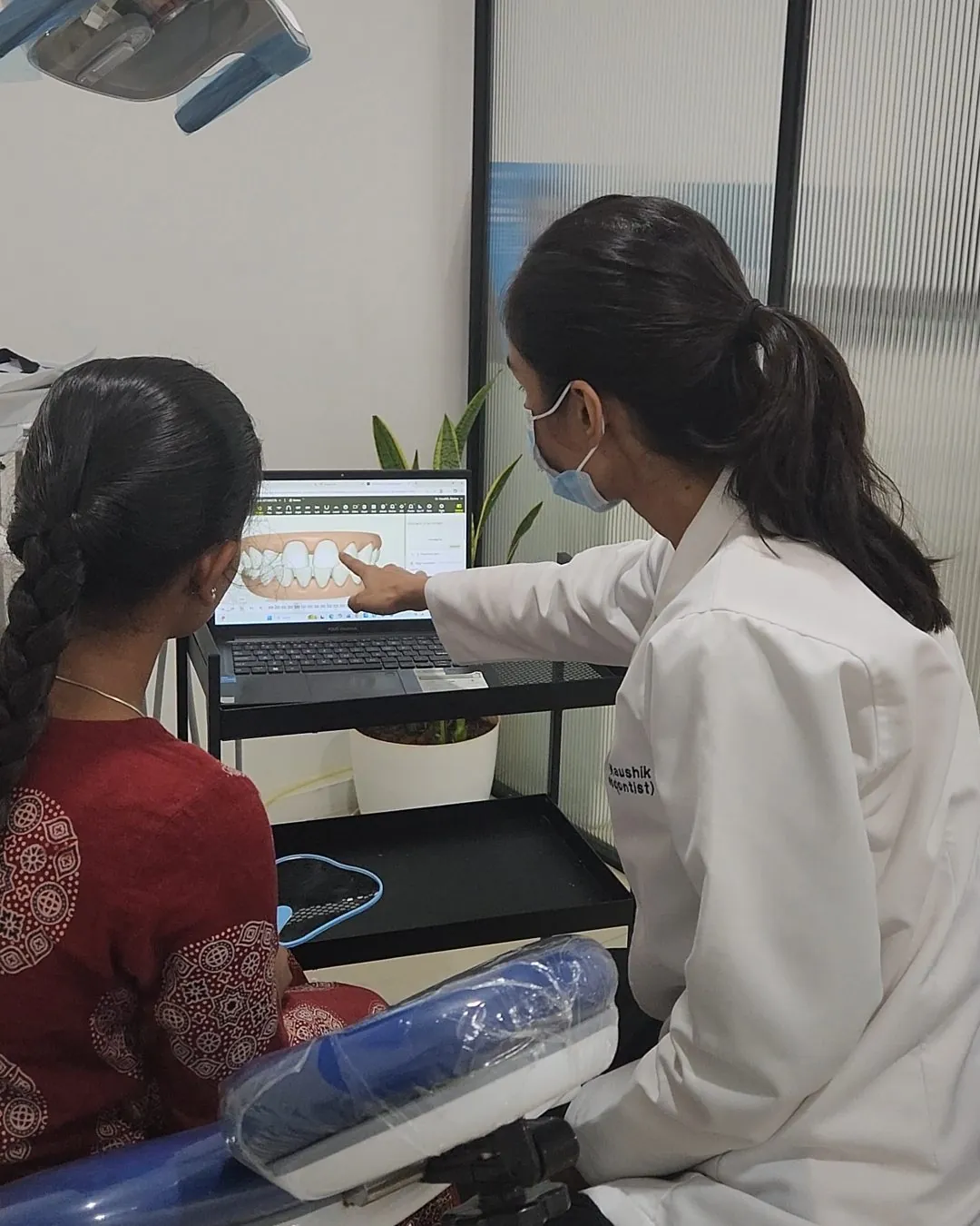 Dr. Garima Kaushik explaining a treatment to a young patient at Vita Dental Clinic, Bellandur